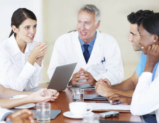 Image: Doctors talking to each other around a table