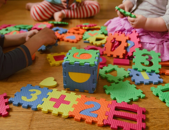 Image: children playing with foam puzzle pieces
