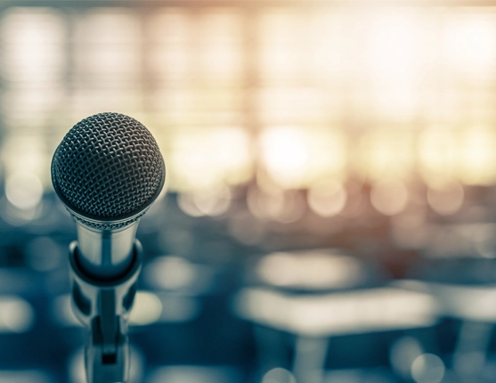 Image: image of microphone with auditorium in background