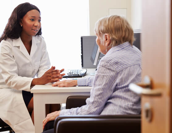 Image: Female doctors meeting with elderly female patient.