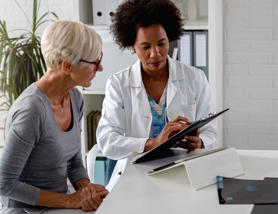 Image: Female doctor talking with female patient.