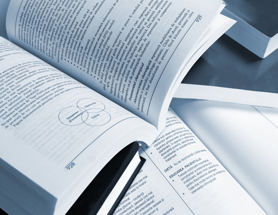 Image: Stack of open textbooks placed on top of each other.