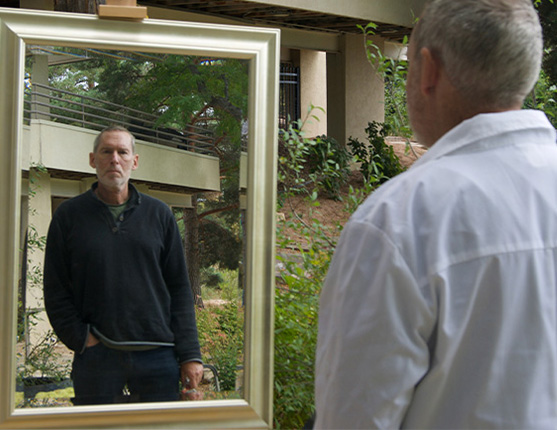 Image: Cover image featuring man looking at reflection in mirror