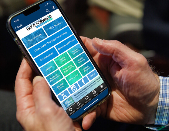 Image: hands holding phone with ASTRO 2023 Annual Meeting App on screen