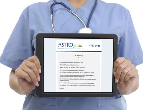 Image: Doctor holding a tablet with the ASTROgram newsletter shown on screen