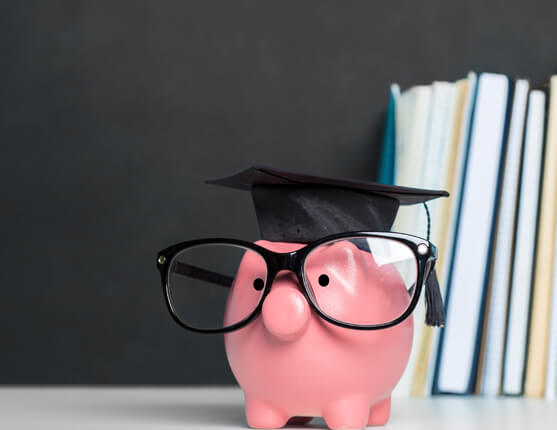 Image: piggy bank with grad cap and books