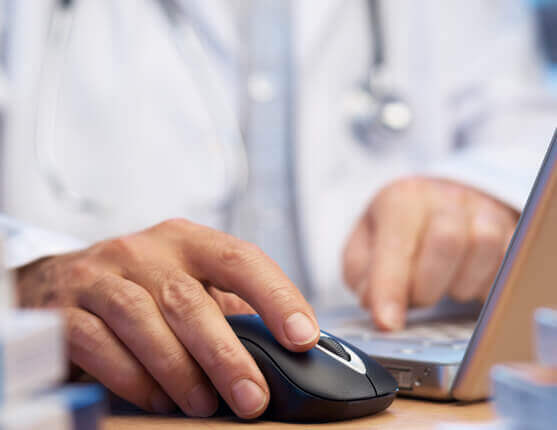 Image: Hand holding a computer mouse