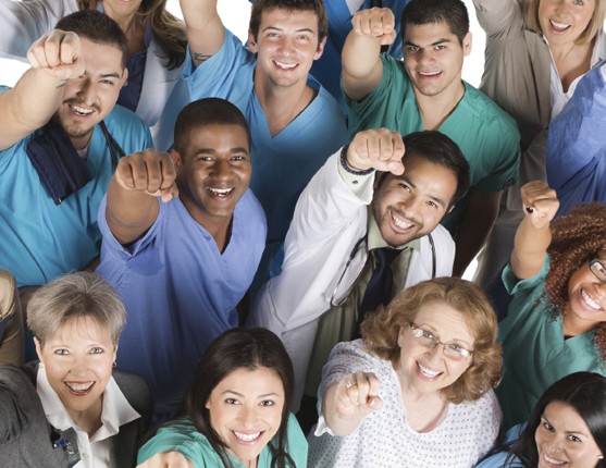 Image: Group of medical professionals pointing up to camera