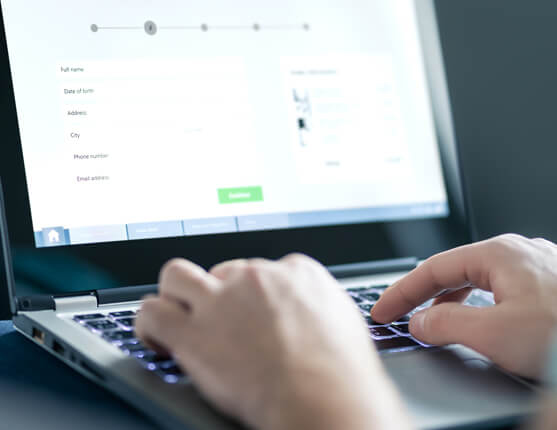 Image: person at laptop registering for a meeting