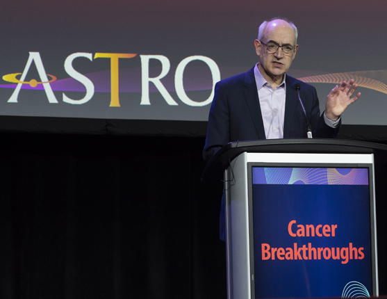 Image: Man speaking at Podium from Cancer Breakthroughs session at ASTRO 2022
