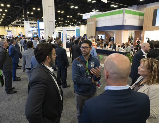 Image: Attendees talking in Exhibit Hall