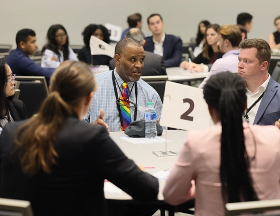Image: Groups sitting around table at speed mentoring event