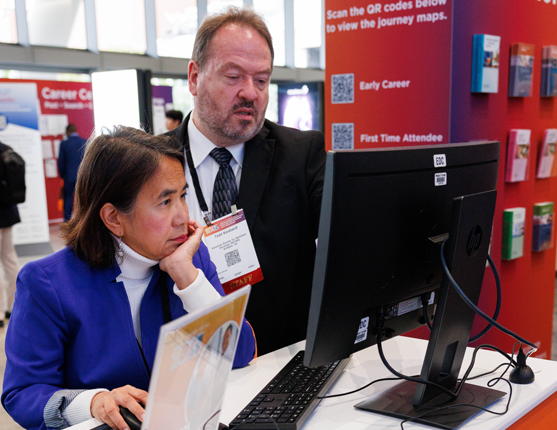 Image: ASTRO staff and Attendee at ASTRO Resource Center