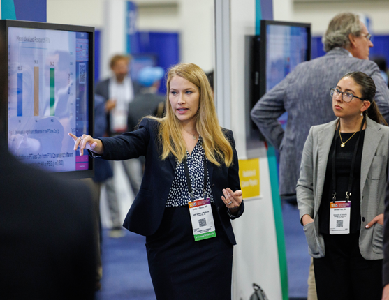 Image: Annual Meeting attendee at poster kiosk