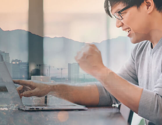 Image: Man at computer with meeting phoenix skyline in background