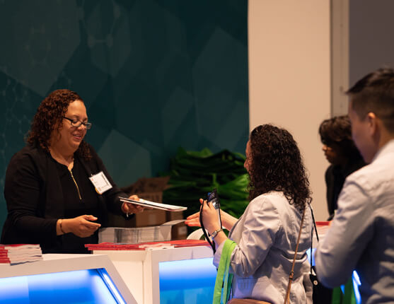 Image: Attendees picking up registration materials