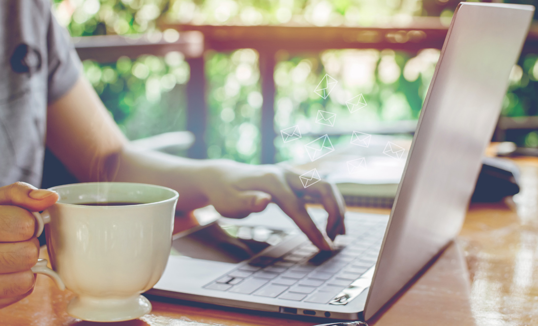 Image: Person at computer with coffee